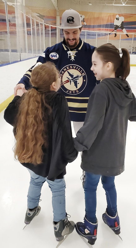Alex Thundercloud, ICS Alumnus assists 3rd grade students learning to skate on the ice.